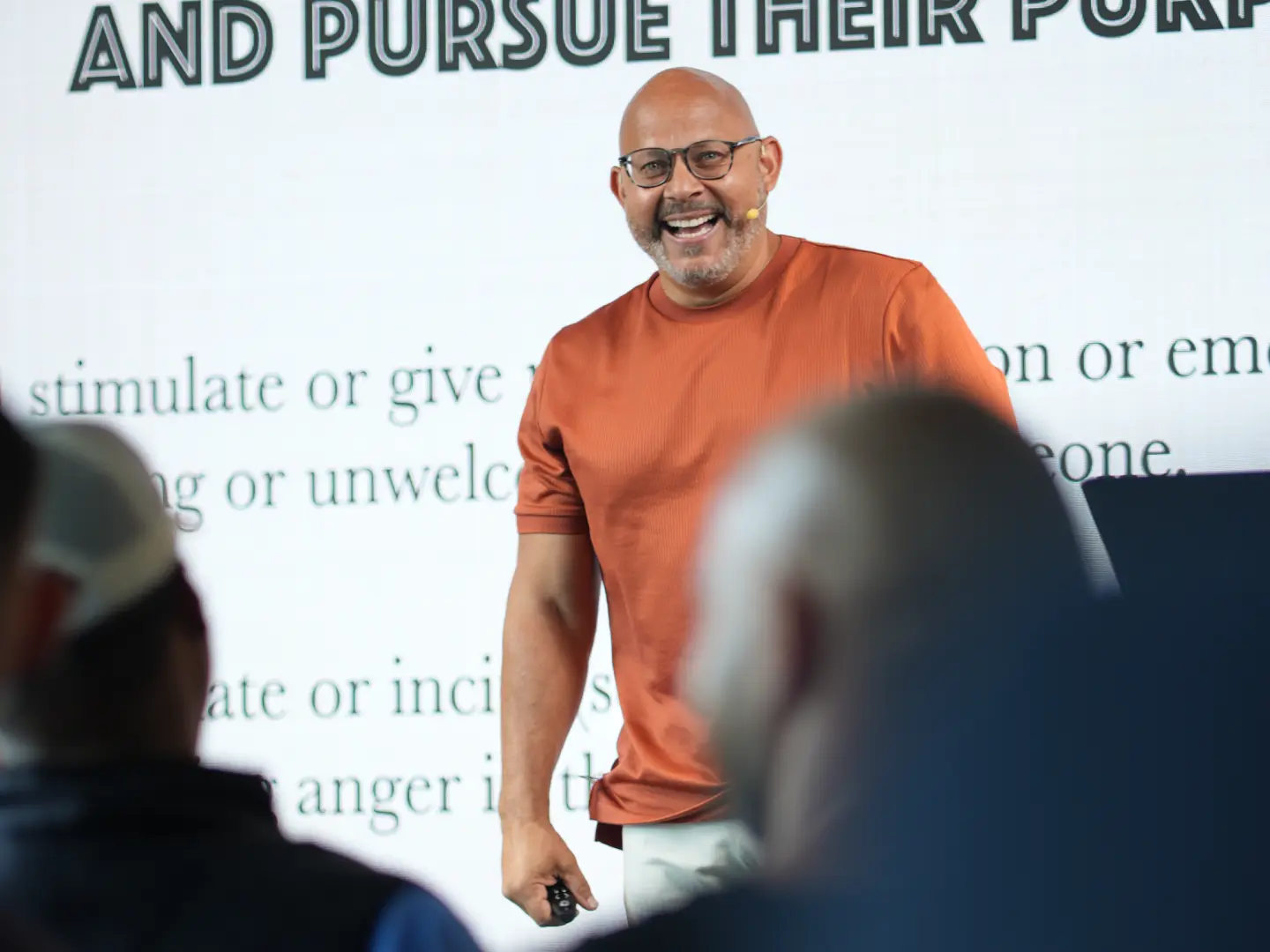 In Person and Virtual Event Space - Speaker presenting on stage