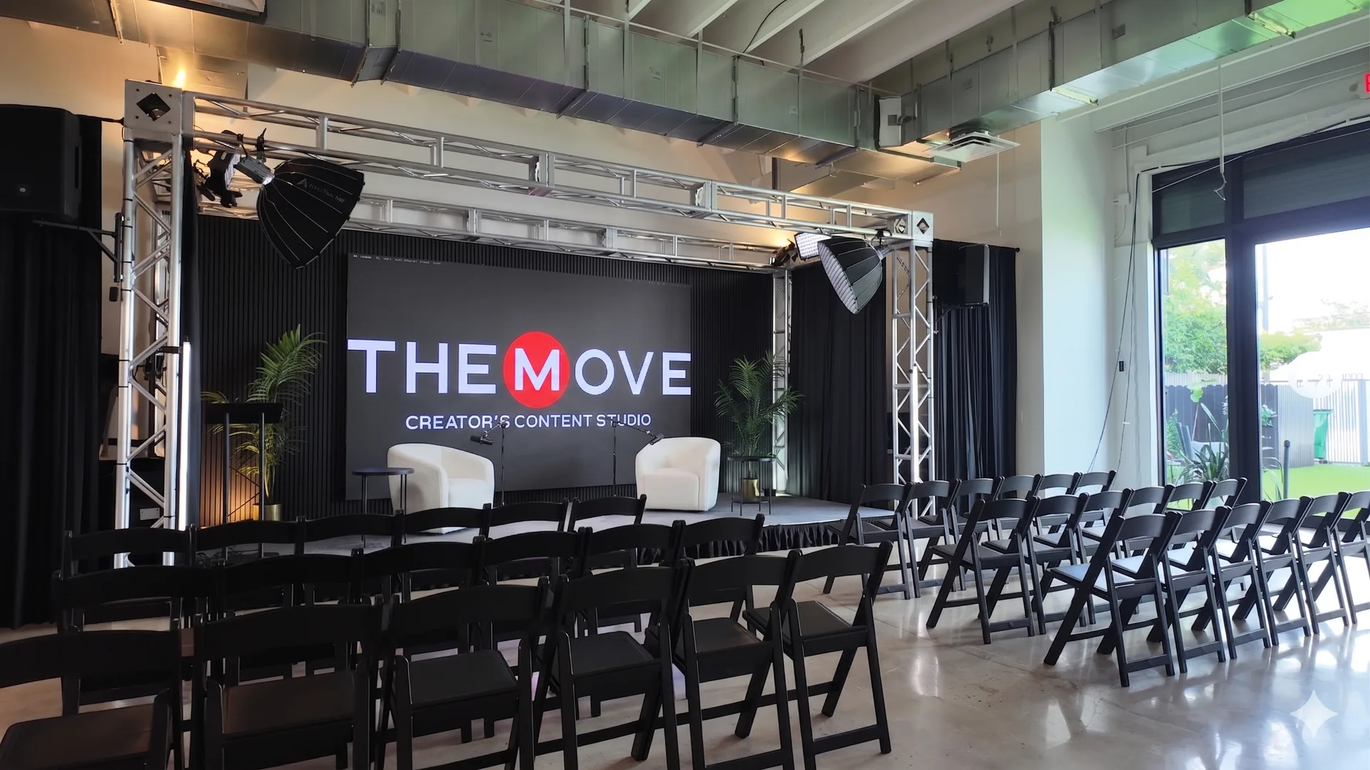 In Person and Virtual Event Space - Stage with white chairs setup